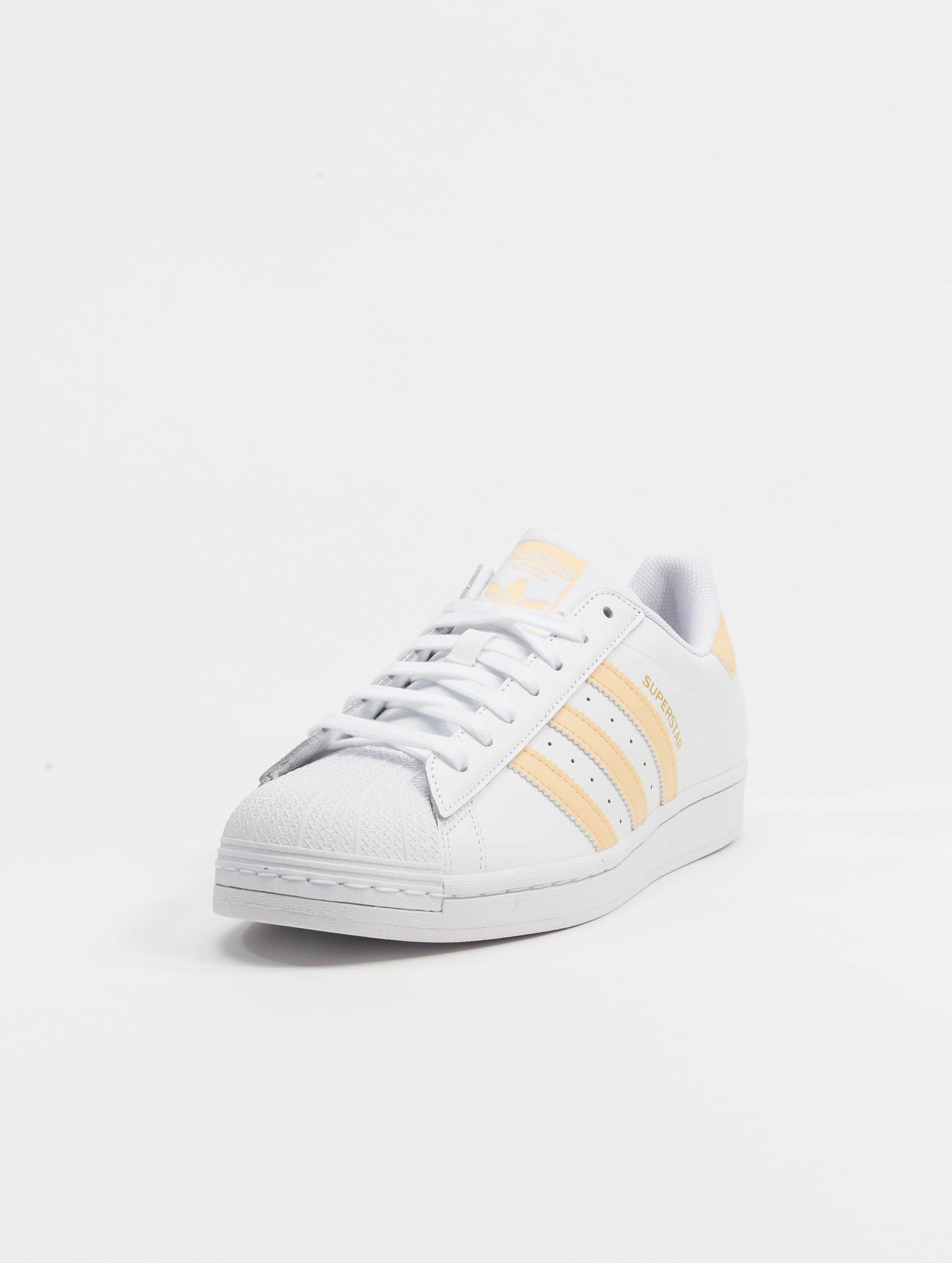 Gold stripe adidas superstars best sale