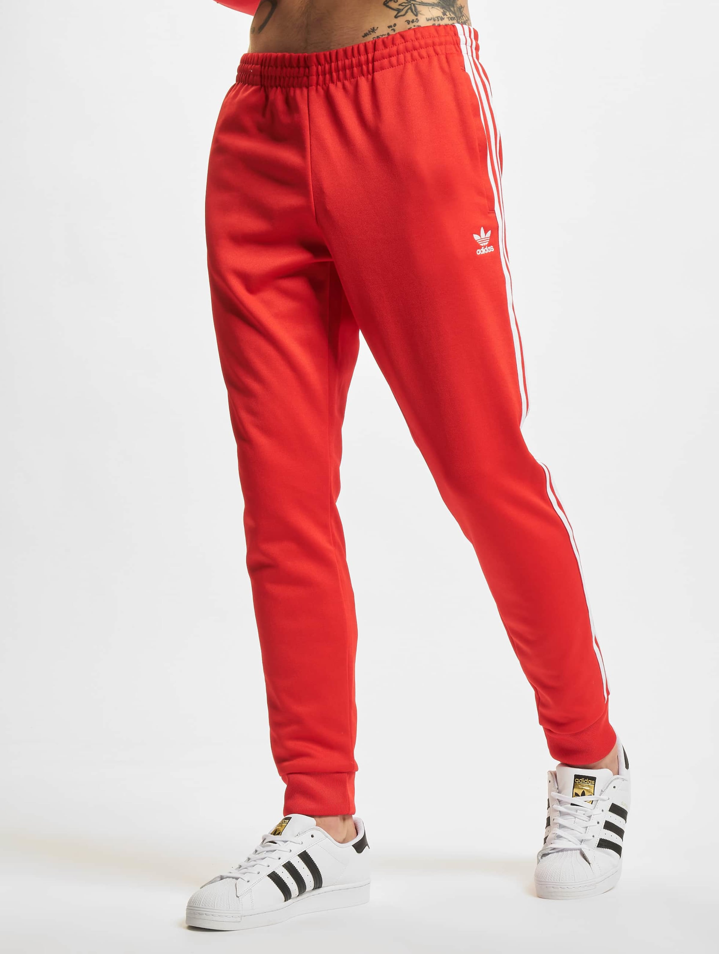 Adidas red hotsell sst track pants