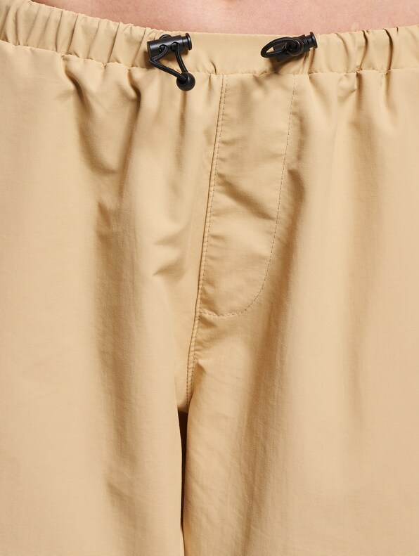 Shop KARL KANI Small Signature Parachute Pants [off white] by Vol_Tina